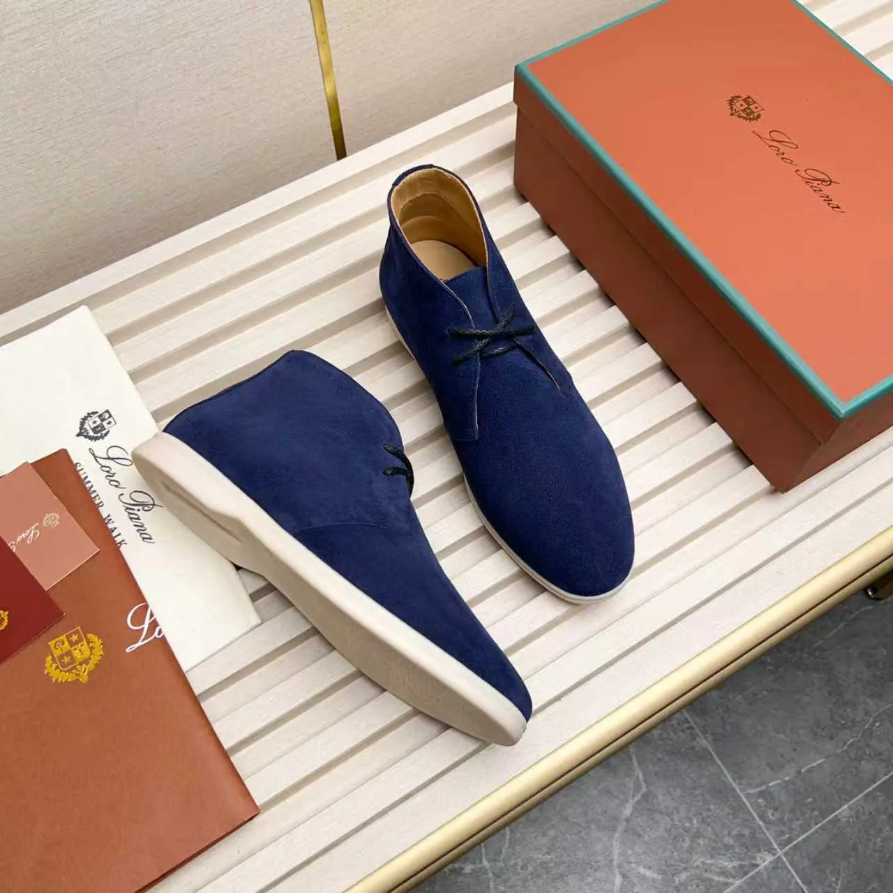 Men's Shoes 💰420 Loro Piana reimagines the desert boot—a modern, comfortable interpretation of a classic 1940s style. Crafted from suede calfskin, it exudes elegance. The tight texture of suede calfskin is not only durable but also looks casual and sophisticated. Add a timeless piece to your shoe collection, harmoniously blending comfort, style and Loro Piana's heritage of craftsmanship. Acetate satin detail on the inside White sole with LP lettering for added traction Space for a personalized signature on the heel Tonal suede trim Upper: 100% cow split suede Sole: 100% Rubber lining: Cow leather